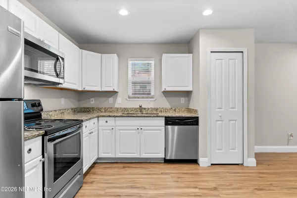 a kitchen with stainless steel appliances granite countertop a stove and a sink