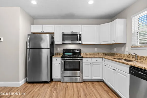 a kitchen with a refrigerator stove and sink