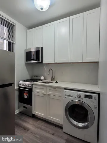 a kitchen with a sink and a stove top oven
