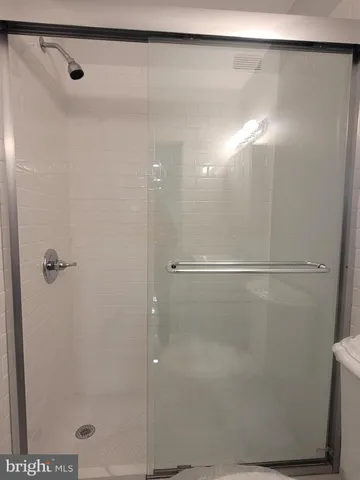 a bathroom with a glass shower door