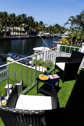 a view of a lake with couches chairs