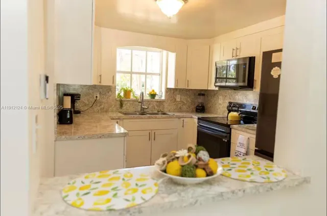 a kitchen with a sink stove and cabinets