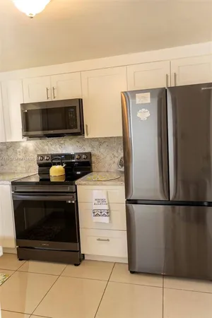 a kitchen with a refrigerator stove and microwave