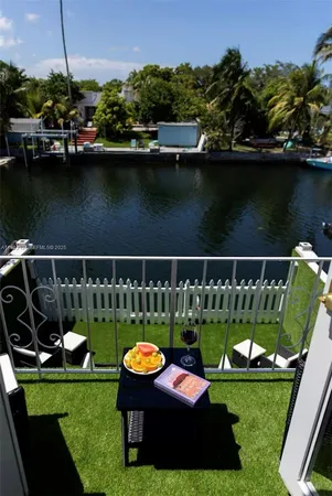 a view of a deck with chairs next to a yard