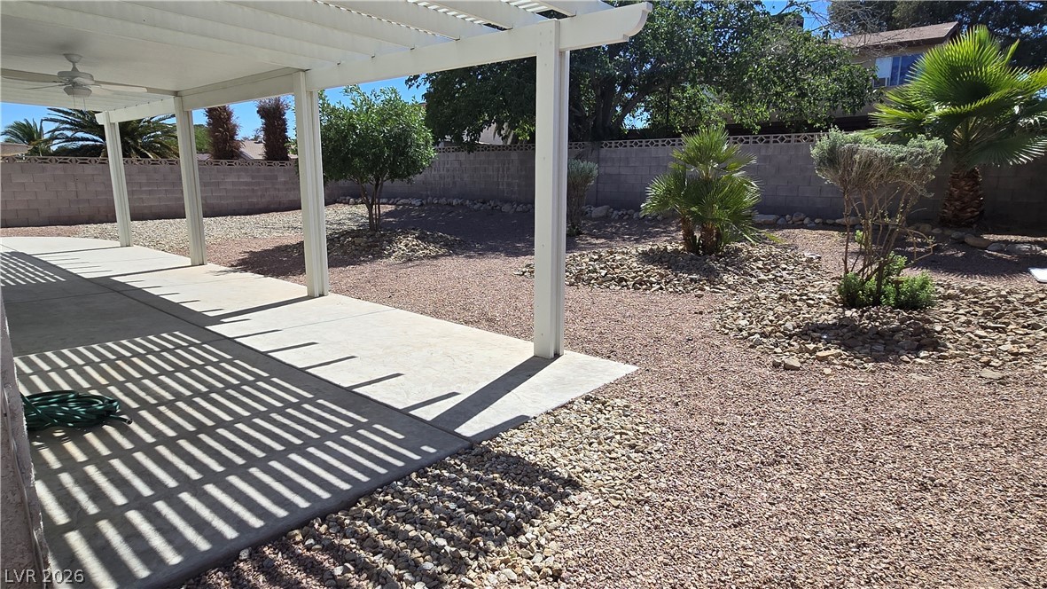 3849 Reflection Way Las Vegas, NV 89147 - Photo 24 of 25 Relax in this tranquil outdoor area with a covered patio, perfect for enjoying the desert landscaping.