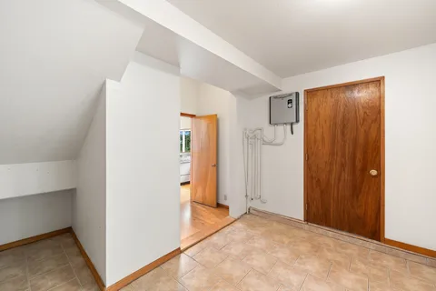 a view of a room with wooden floor and a window