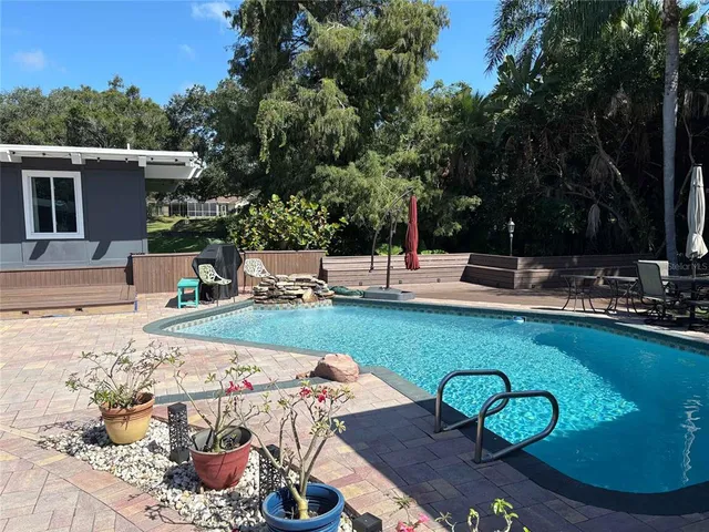 a view of a backyard with plants and patio