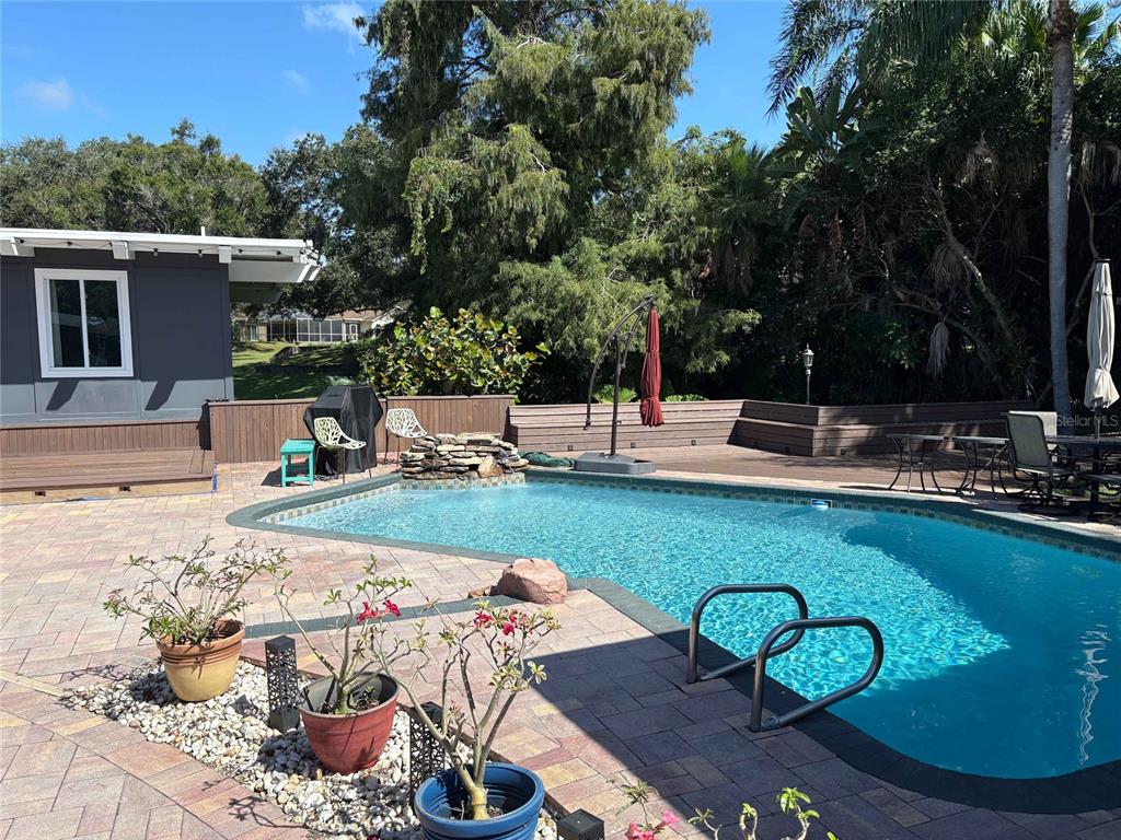 a view of a backyard with plants and patio