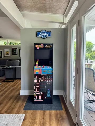 a view of a living room with furniture and wooden floor