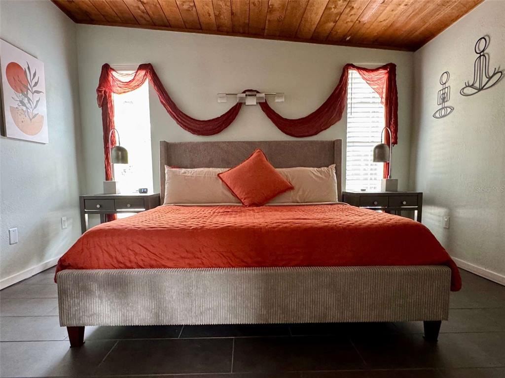 3012 Grand View Avenue Clearwater, FL 33759 - Photo 20 of 43 a bedroom with a bed and glass window