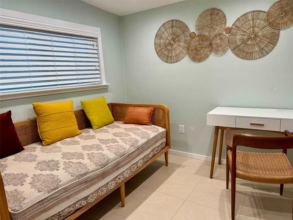 3012 Grand View Avenue Clearwater, FL 33759 - Photo 22 of 43 a bedroom with a bed and a chair