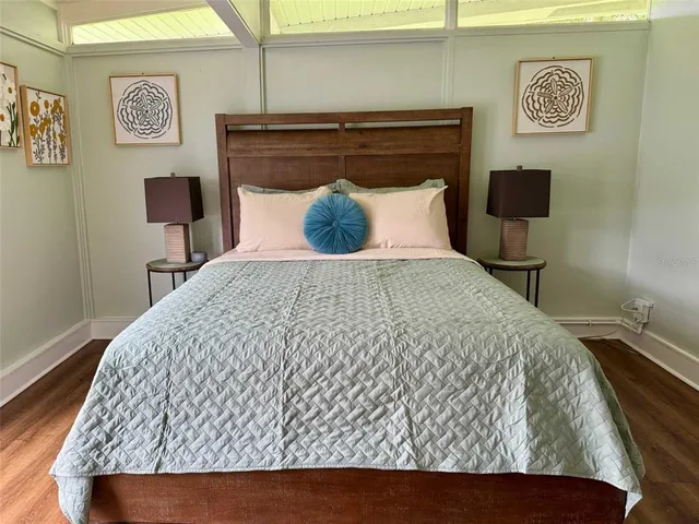 a large bed sitting in a bedroom next to a lamp
