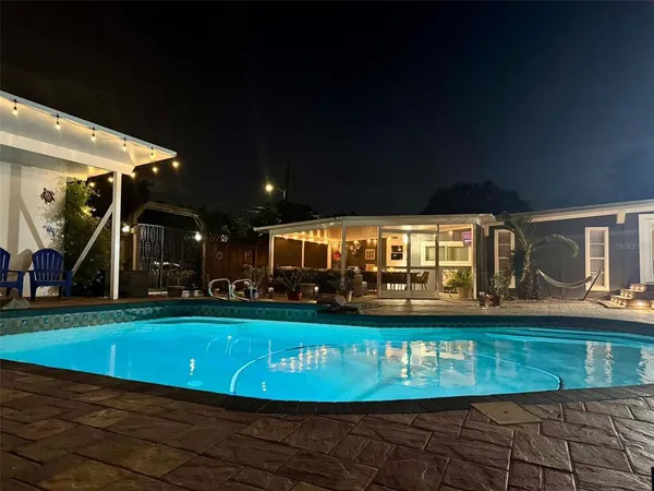 a view of a swimming pool with an outdoor seating
