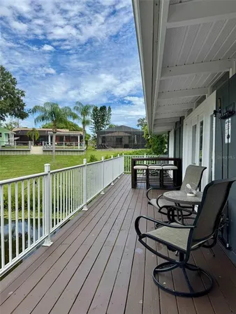 a view of a balcony with furniture and a yard