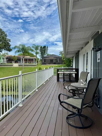 a view of a balcony with furniture and a yard