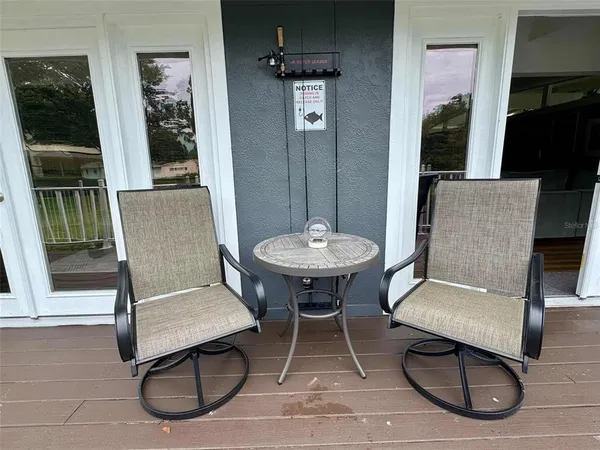 a balcony with wooden floor and fence