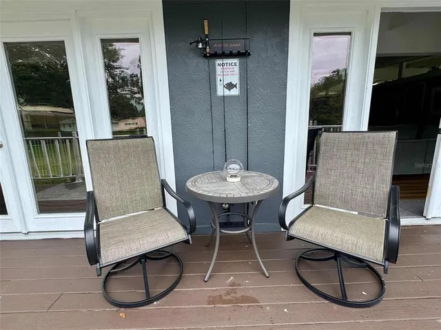 a balcony with wooden floor and fence