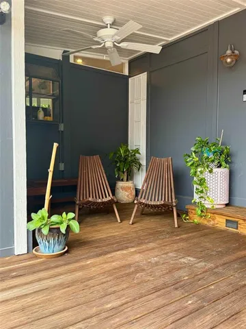 a front view of a house with potted plants