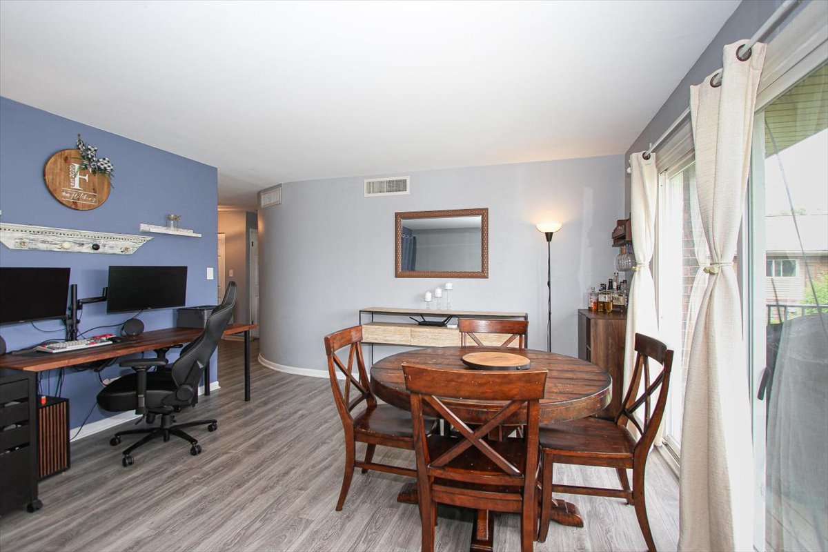 2300 Old Tavern Road, Unit 203 Lisle, IL 60532 - Photo 8 of 26 a view of a dining room with furniture and a window