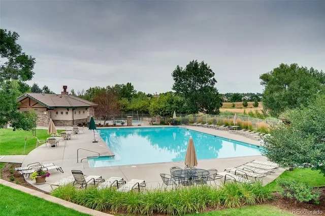 an aerial view of a house with outdoor space lake view and trees all around