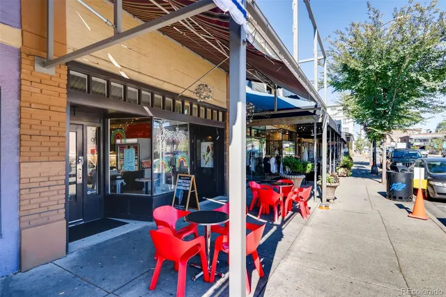 a view of path along with retail shop and outdoor seating