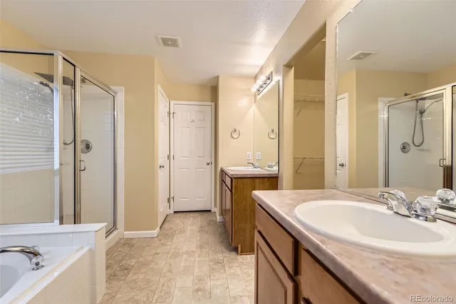 a spacious bathroom with a sink double vanity and a mirror