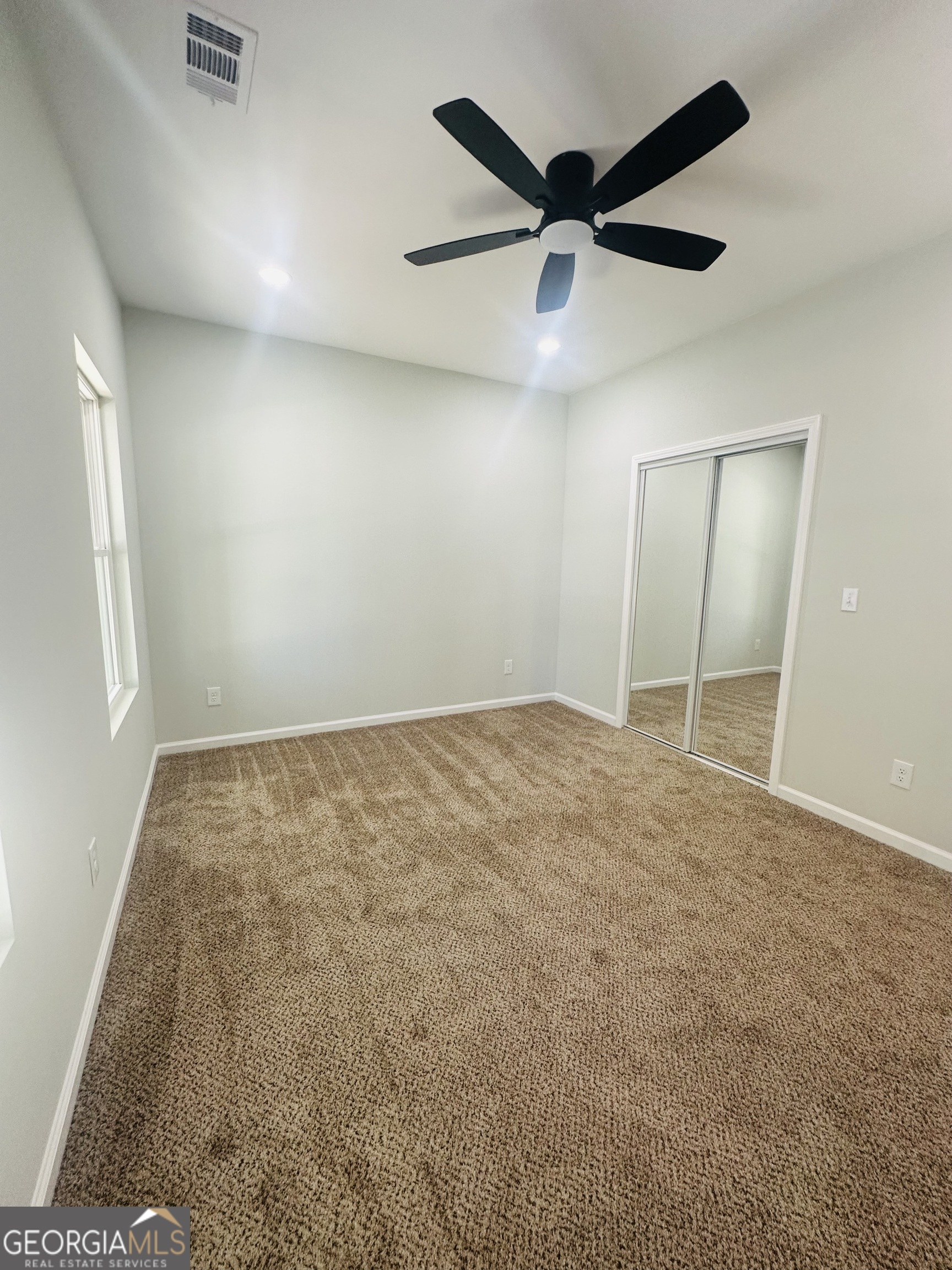 119 F Street Thomaston, GA 30286 - Photo 11 of 27 an empty room with ceiling fan and window