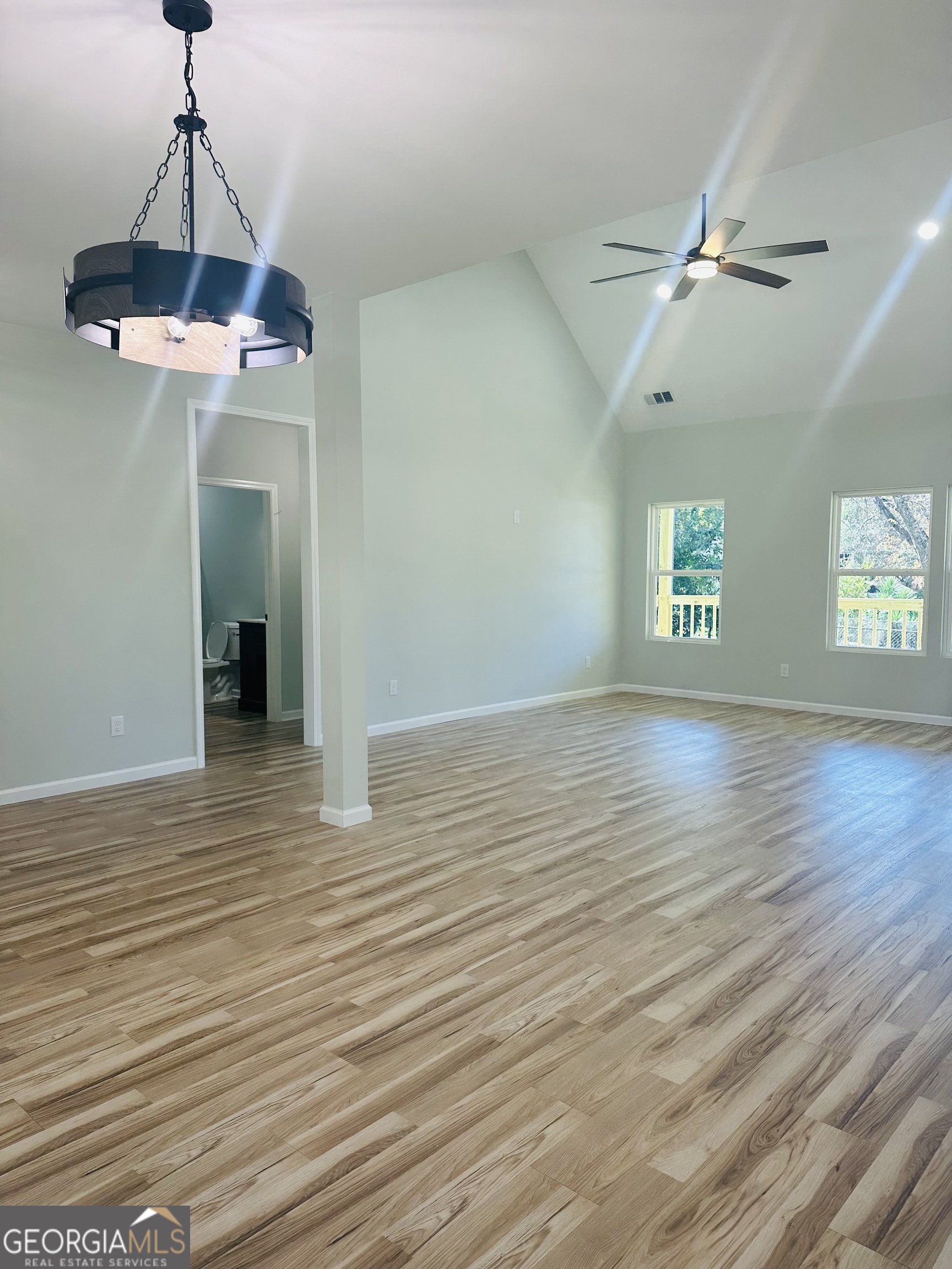 119 F Street Thomaston, GA 30286 - Photo 18 of 27 a view of an empty room with window and wooden floor