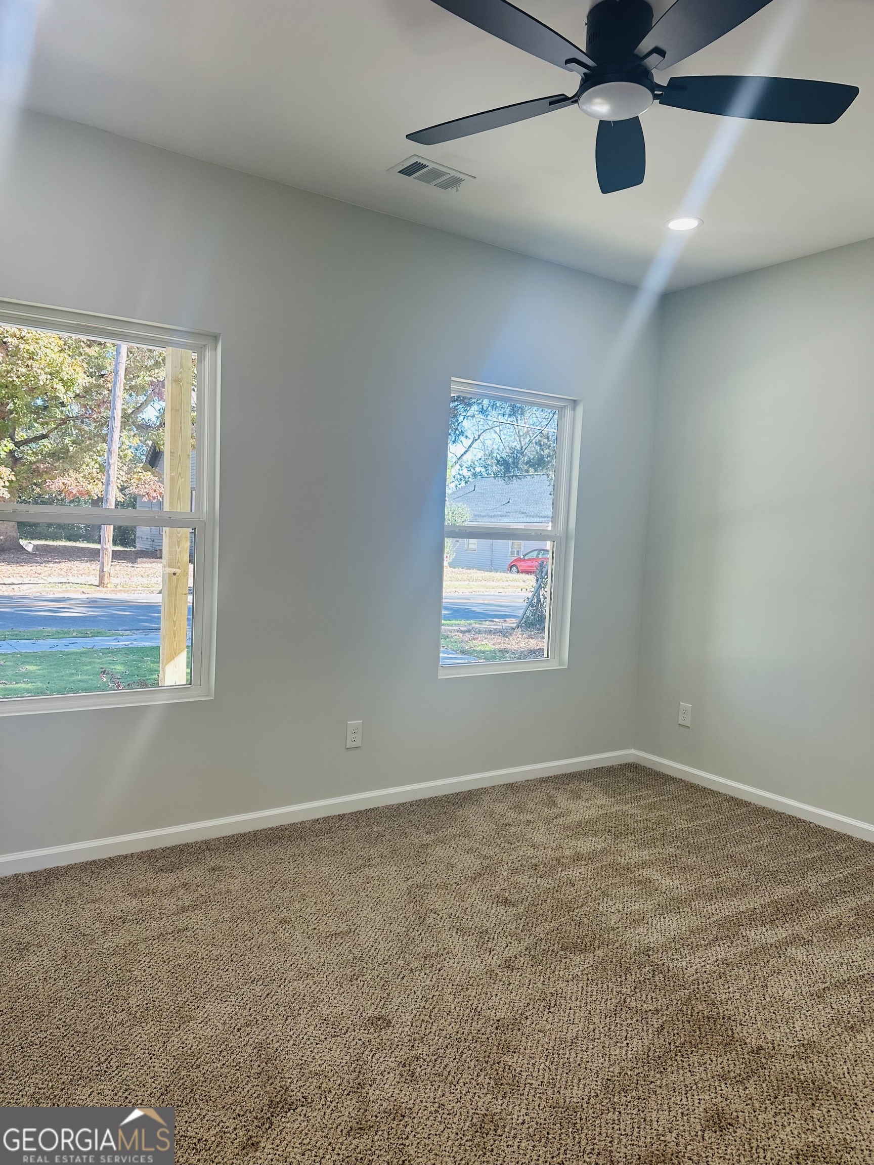 119 F Street Thomaston, GA 30286 - Photo 20 of 27 an empty room with a window and a ceiling fan