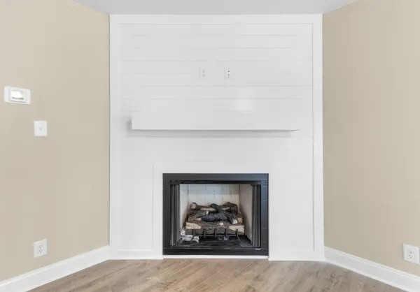 a kitchen with stainless steel appliances granite countertop a refrigerator a sink dishwasher a stove and a large window