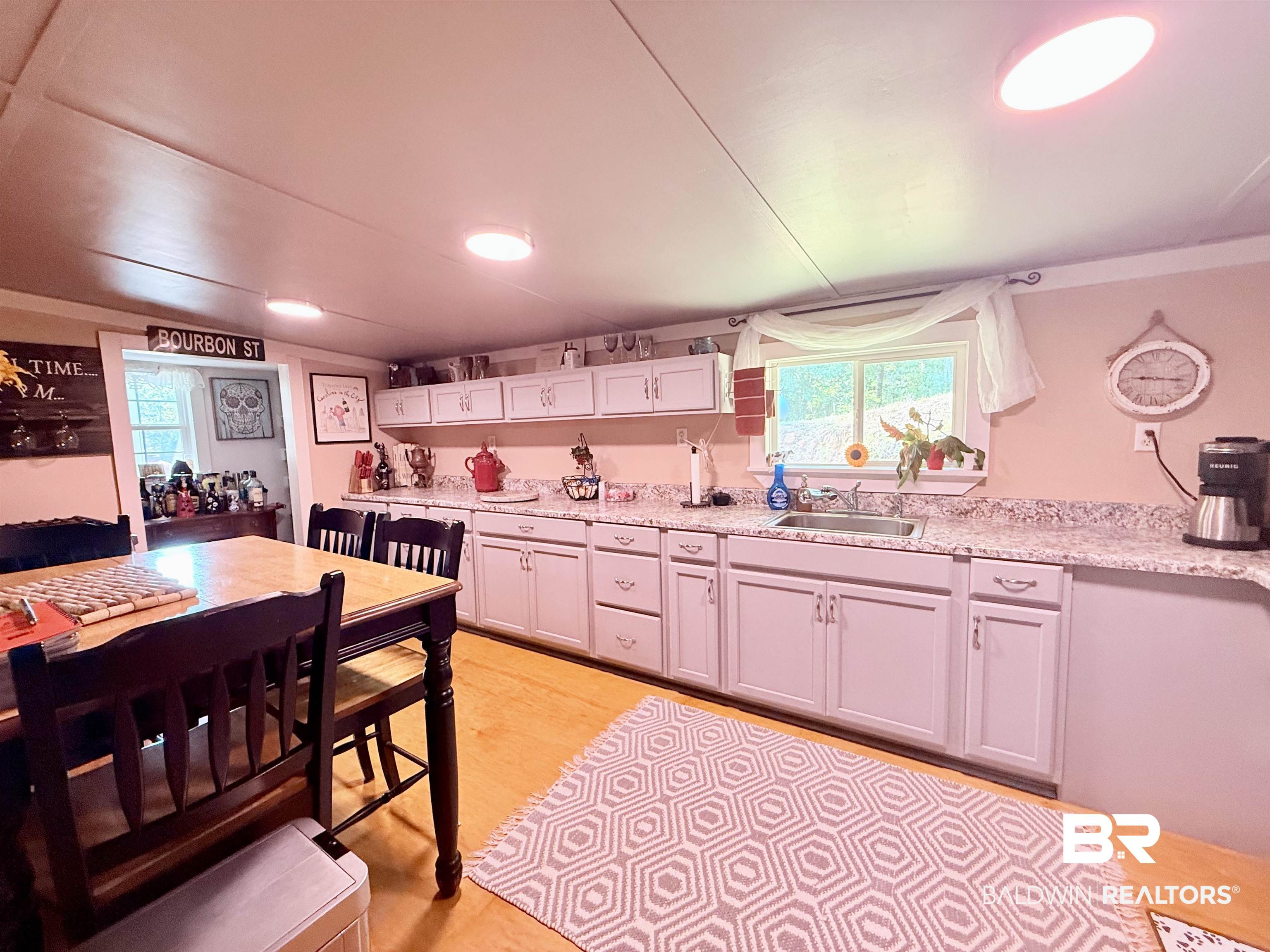 21305 River Road Robertsdale, AL 36567 - Photo 38 of 50 Kitchen with healthy amount of natural light and white cabinetry