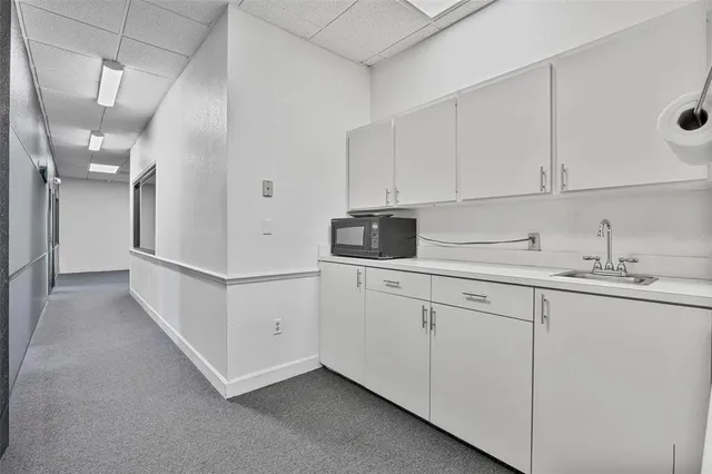 a kitchen with cabinets and white appliances