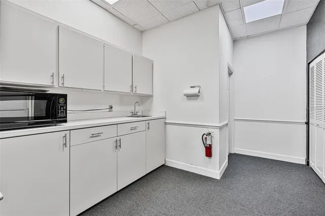a utility room with cabinets washer and dryer