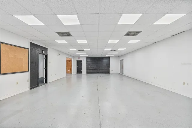 an empty room with a empty space and windows