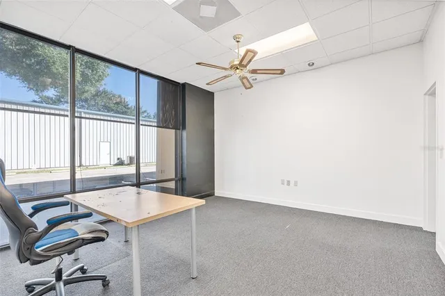 a view of a livingroom with a table and chairs
