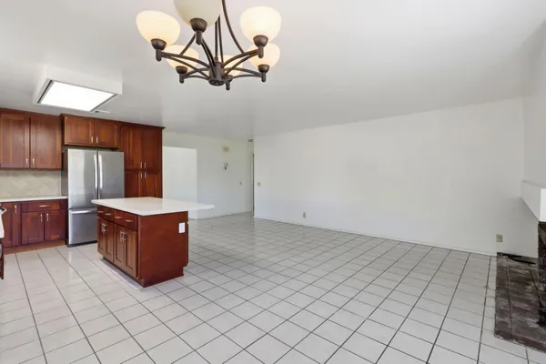 a kitchen with stainless steel appliances a cabinets and window