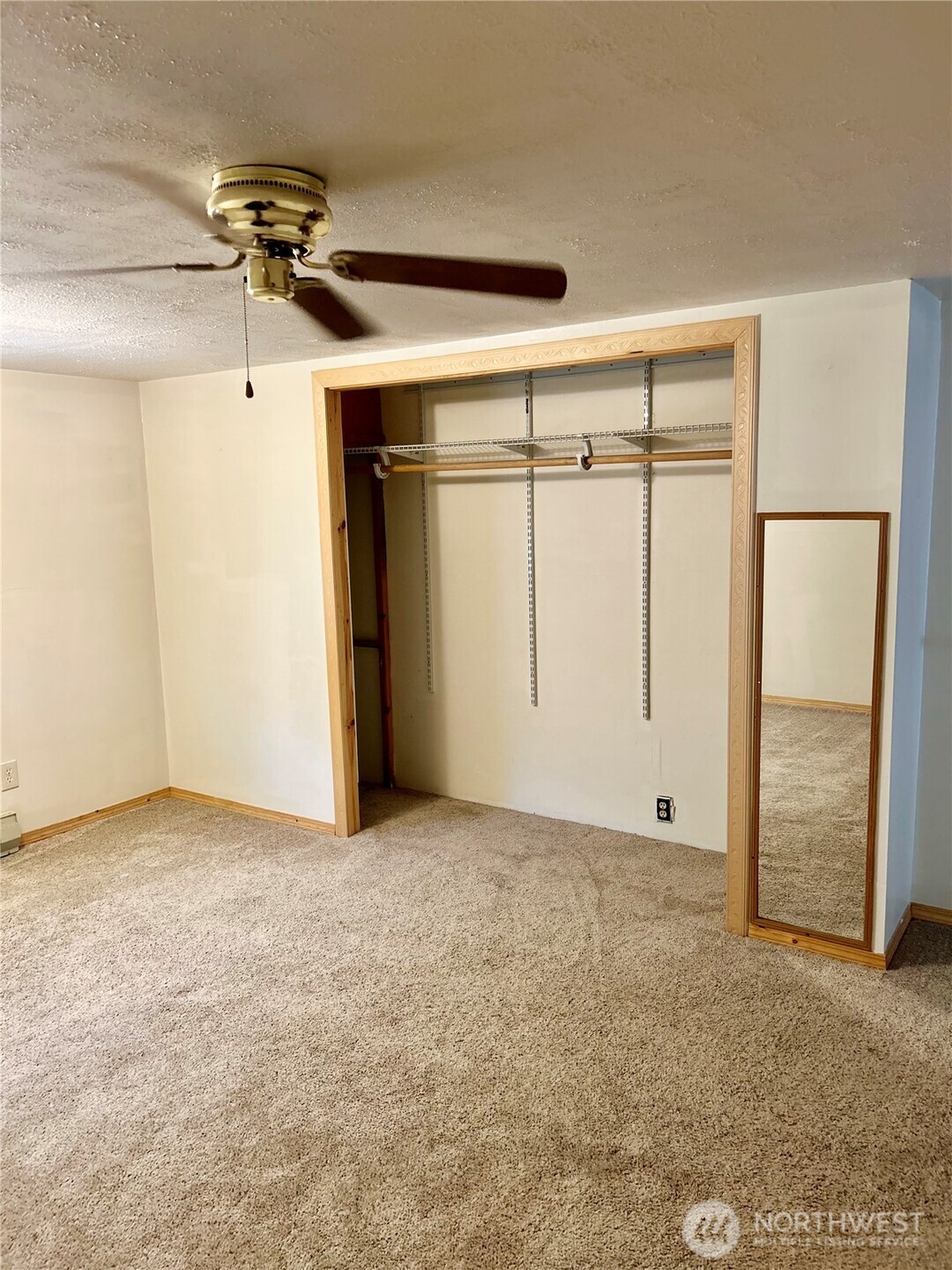 34 Main Street Loomis, WA 98827 - Photo 17 of 18 an empty room with chandelier fan