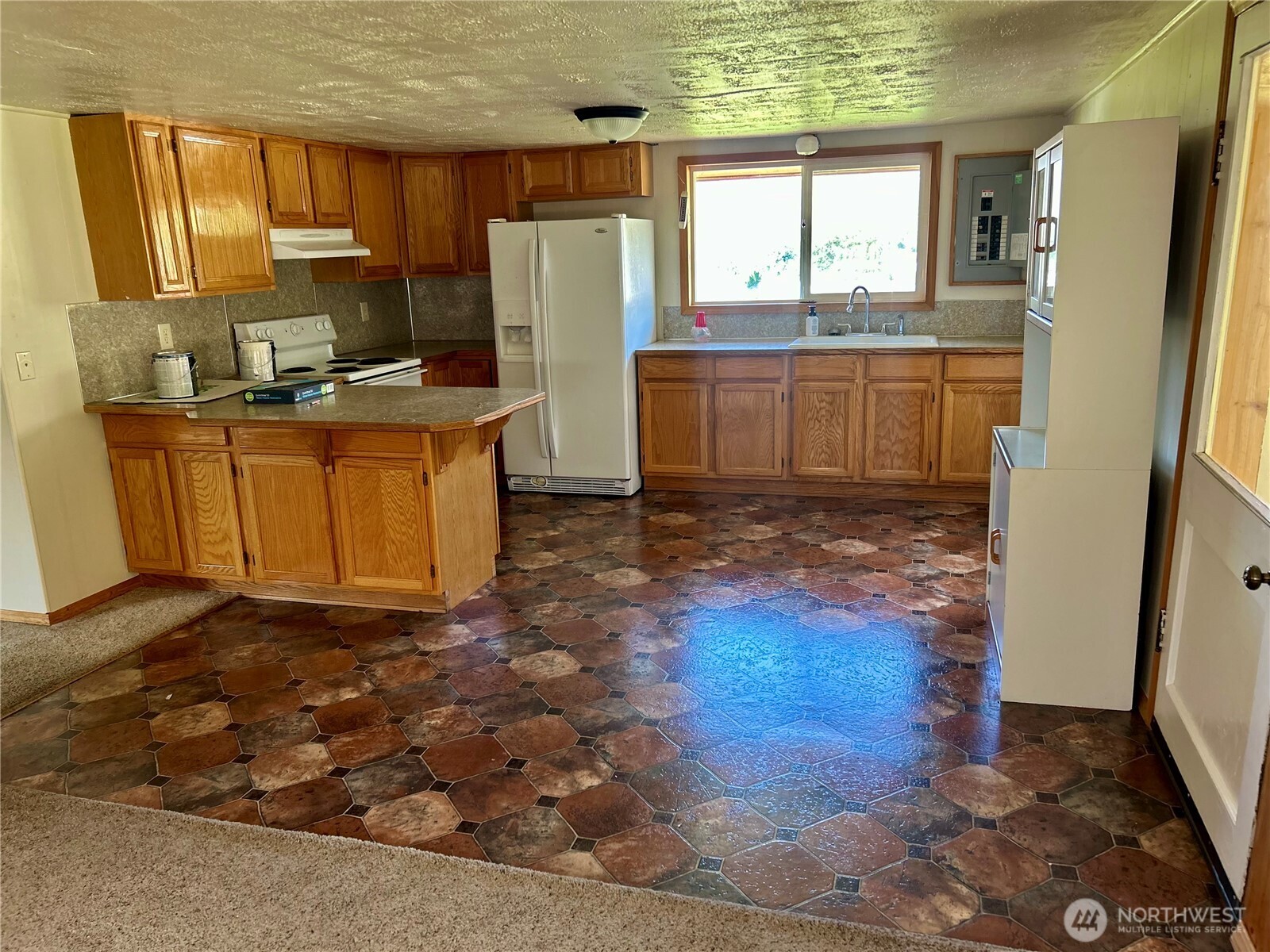 34 Main Street Loomis, WA 98827 - Photo 5 of 18 a kitchen with refrigerator a window and a counter