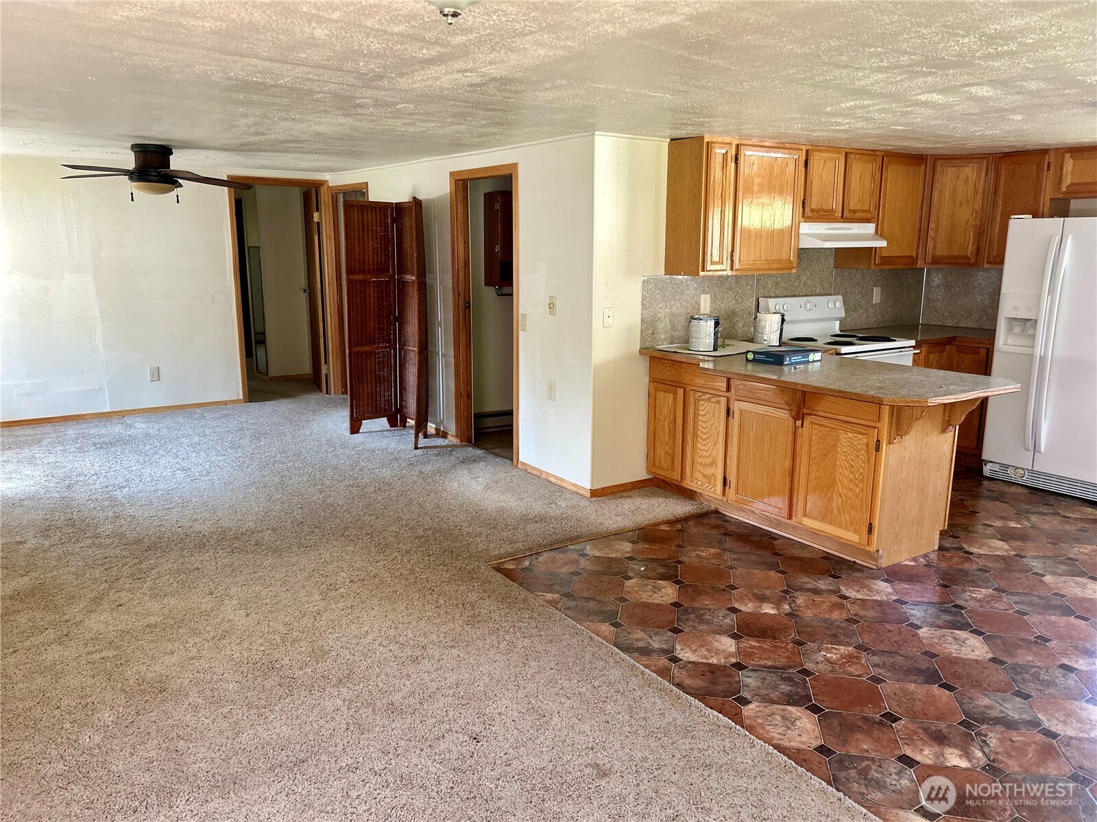 34 Main Street Loomis, WA 98827 - Photo 6 of 18 a view of kitchen with stainless steel appliances granite countertop a refrigerator and a stove top oven