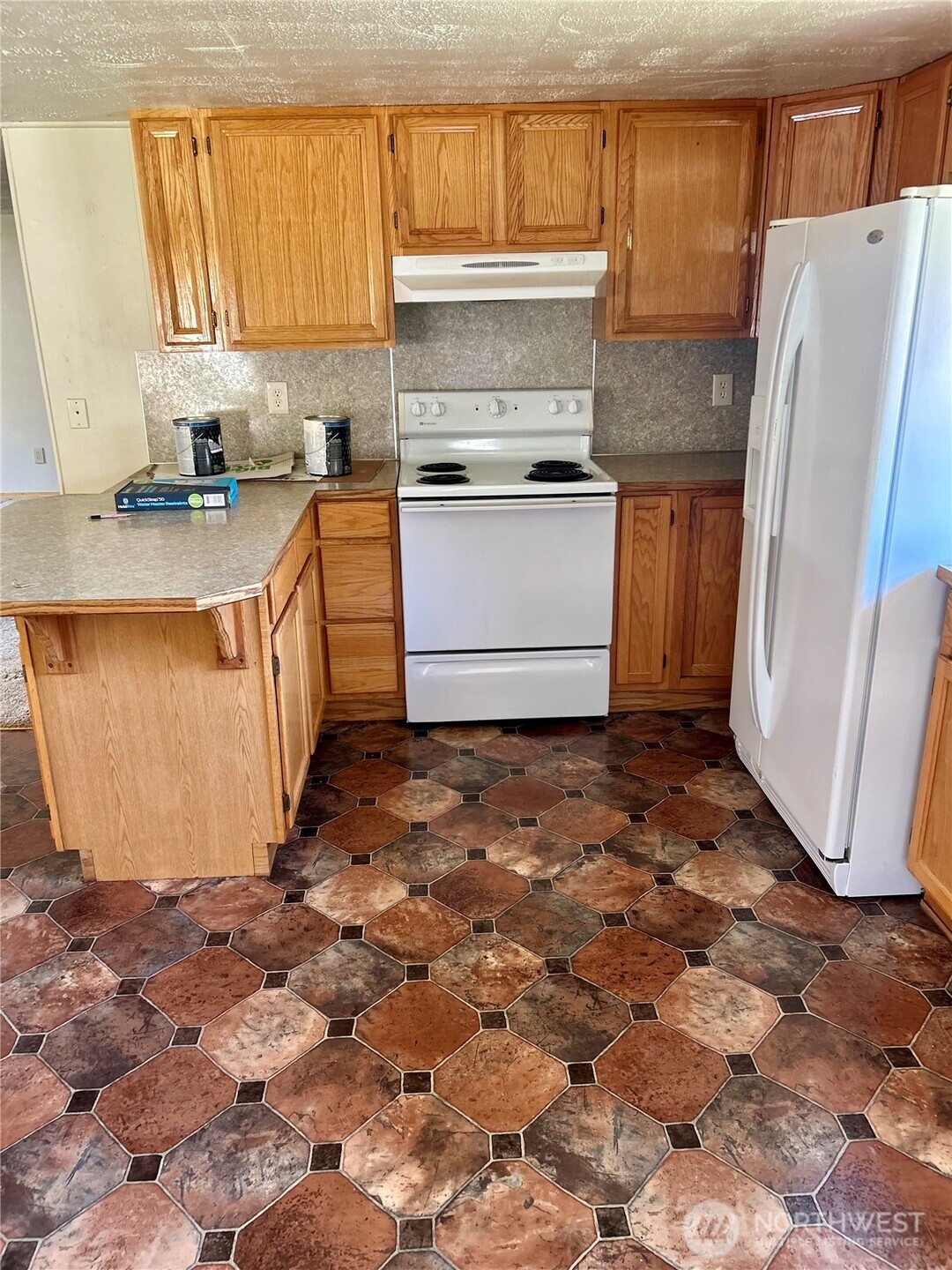 34 Main Street Loomis, WA 98827 - Photo 9 of 18 a kitchen with stainless steel appliances granite countertop a refrigerator a stove a sink and a microwave