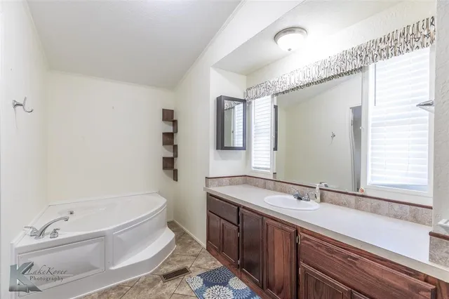 a bathroom with a double vanity sink mirror and toilet