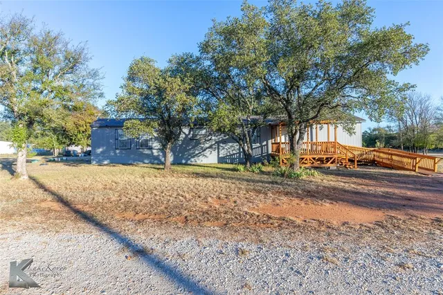 a view of road with large trees