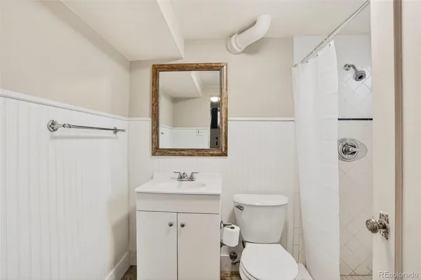 a bathroom with a toilet sink shower and mirror