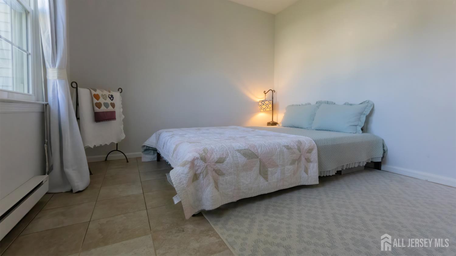 320 Sharon Way, Unit B Monroe Township, NJ 08831 - Photo 12 of 35 a bedroom with a bed and a window