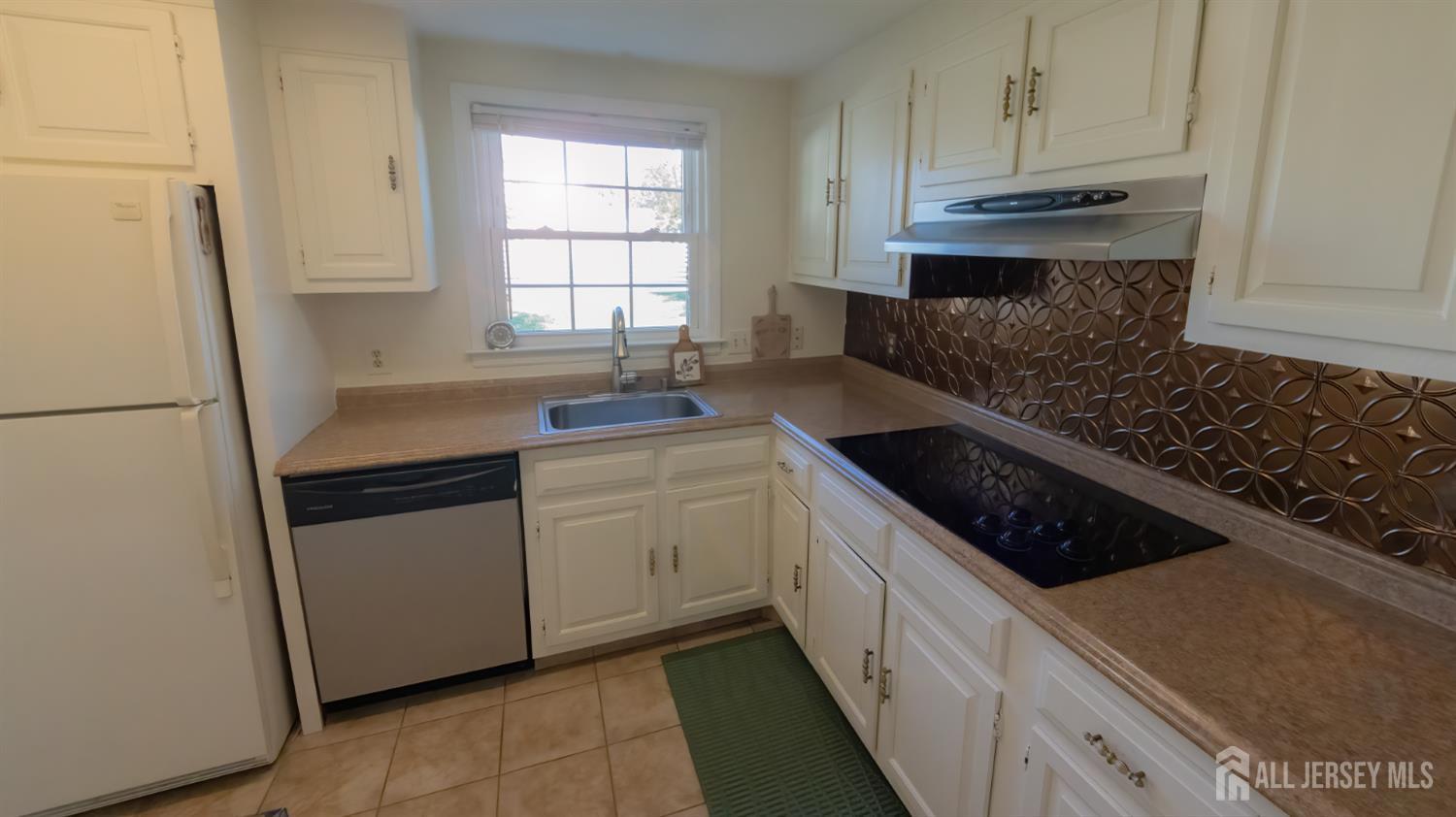 320 Sharon Way, Unit B Monroe Township, NJ 08831 - Photo 21 of 35 a kitchen with granite countertop a sink stove and refrigerator