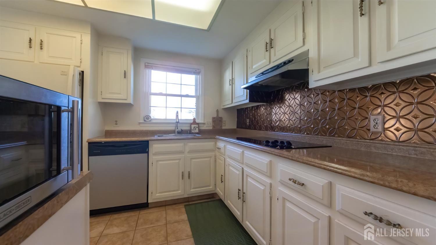 320 Sharon Way, Unit B Monroe Township, NJ 08831 - Photo 22 of 35 a kitchen with granite countertop white cabinets stainless steel appliances and a sink