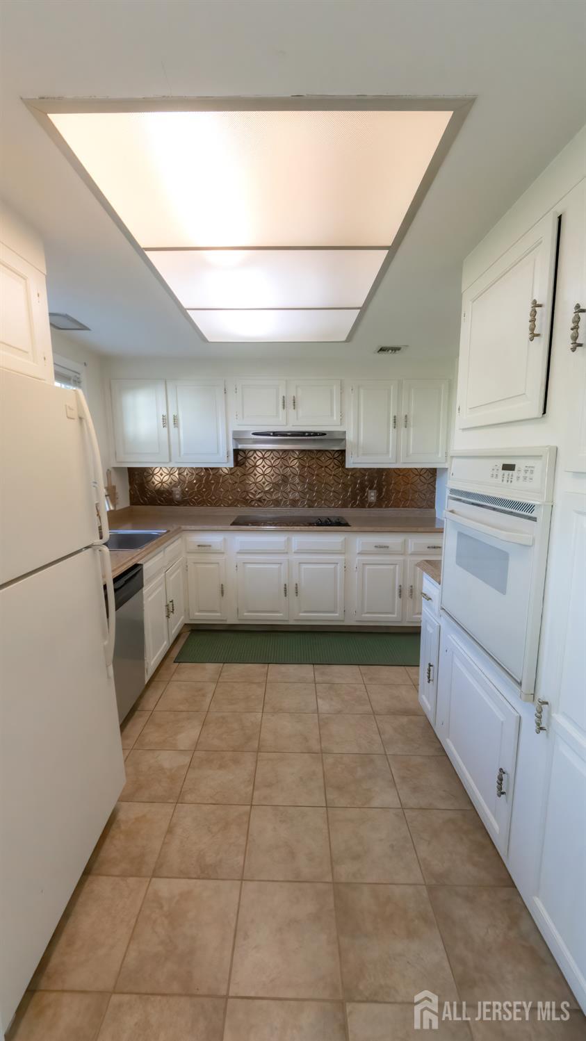 320 Sharon Way, Unit B Monroe Township, NJ 08831 - Photo 23 of 35 a kitchen with stainless steel appliances granite countertop a refrigerator and a stove