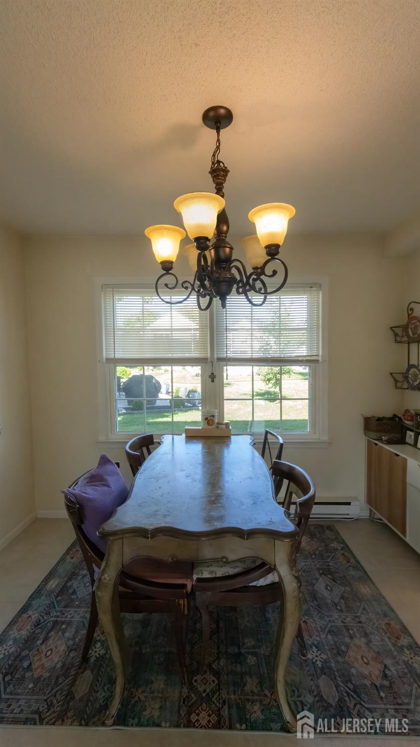 320 Sharon Way, Unit B Monroe Township, NJ 08831 - Photo 28 of 35 a view of a dining room with furniture and chandelier