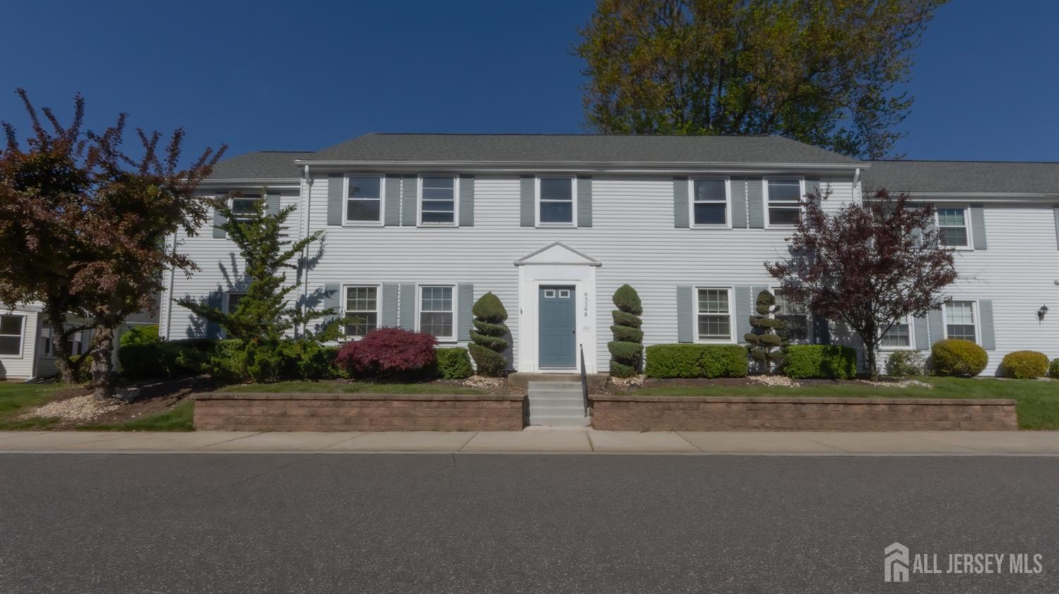 320 Sharon Way, Unit B Monroe Township, NJ 08831 - Photo 3 of 35 a front view of a house with a garden and plants