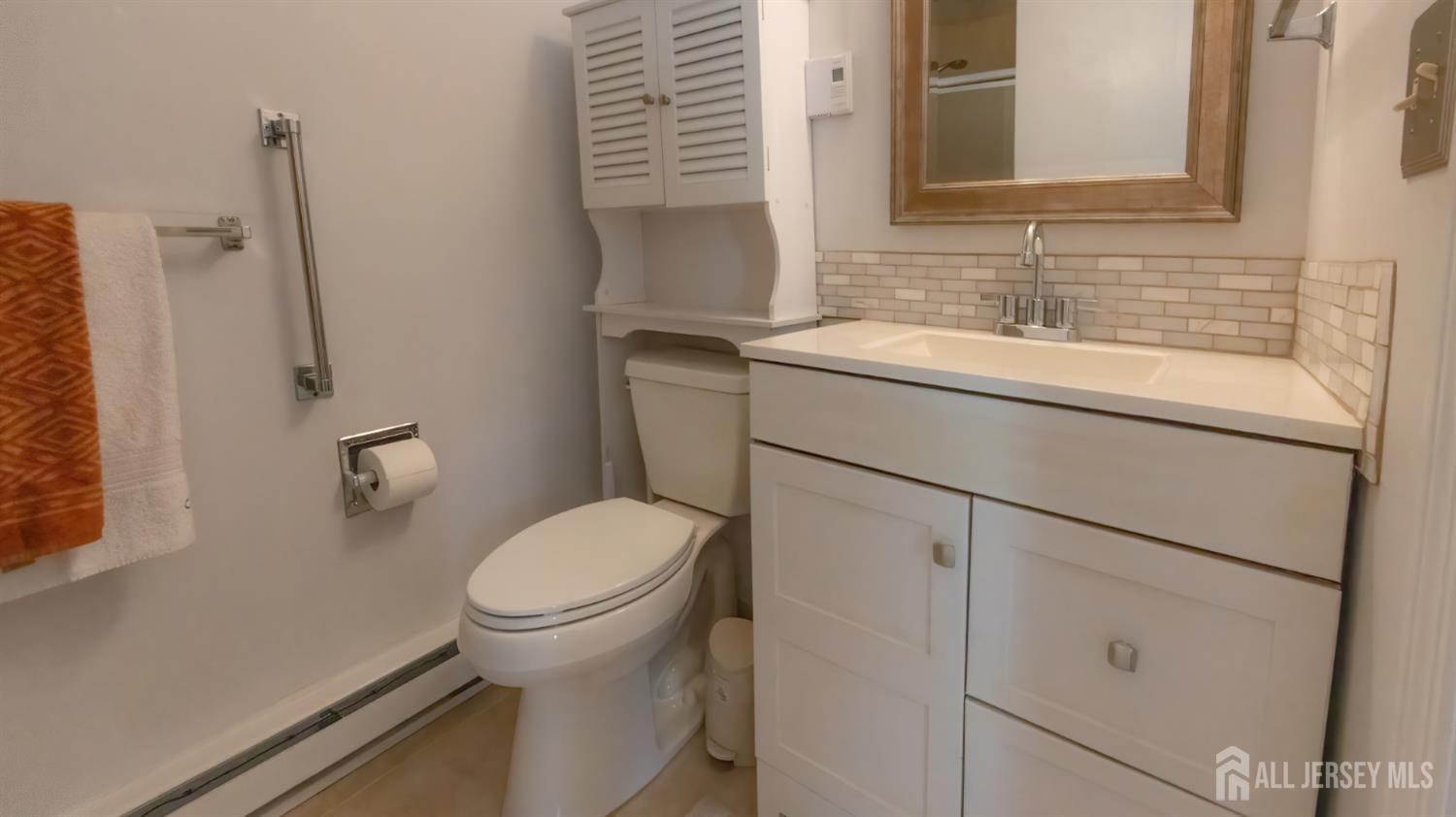 320 Sharon Way, Unit B Monroe Township, NJ 08831 - Photo 32 of 35 a bathroom with a sink toilet and a mirror